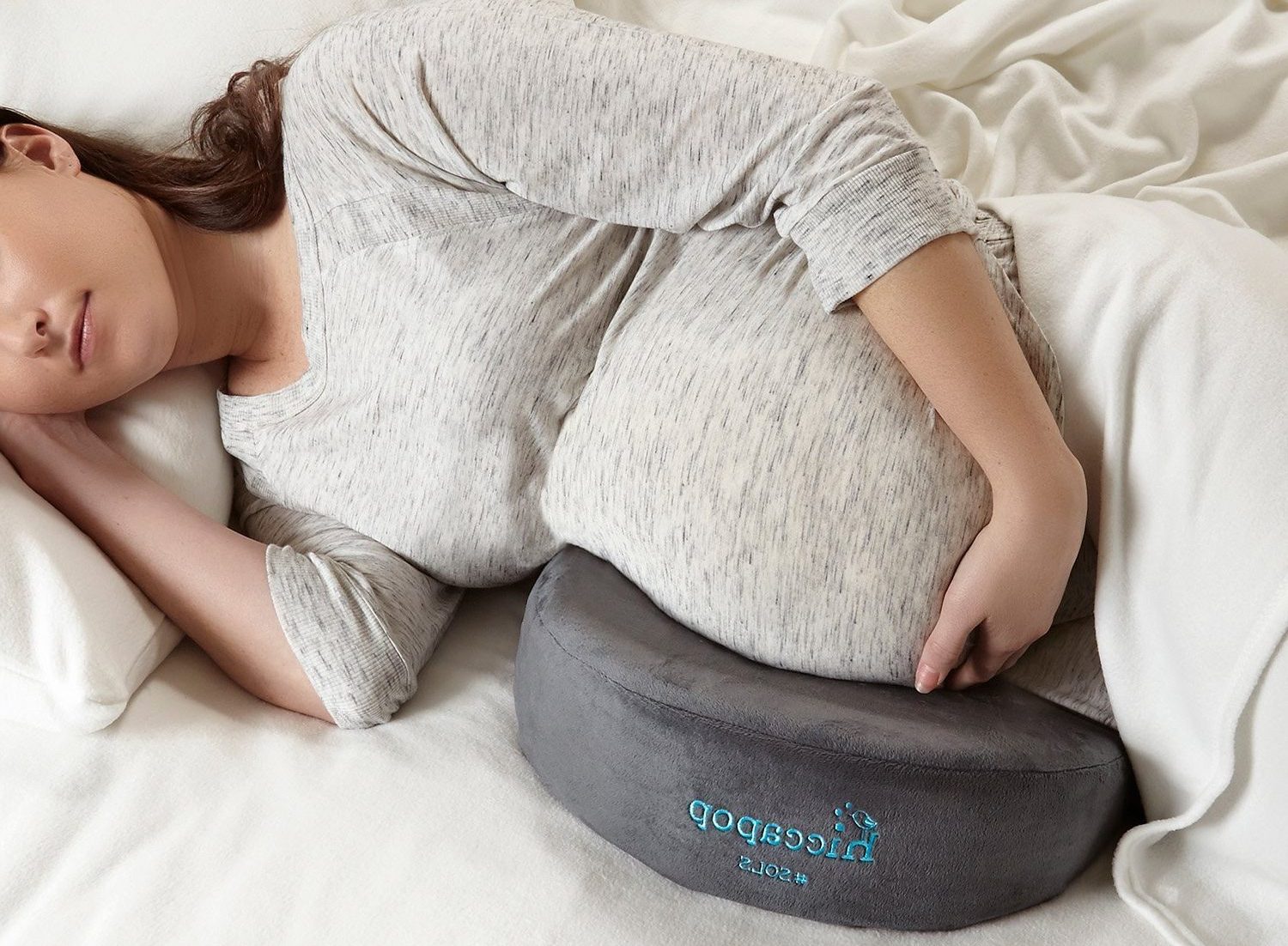 Deborah sleeping on a pillow for pregnant women.